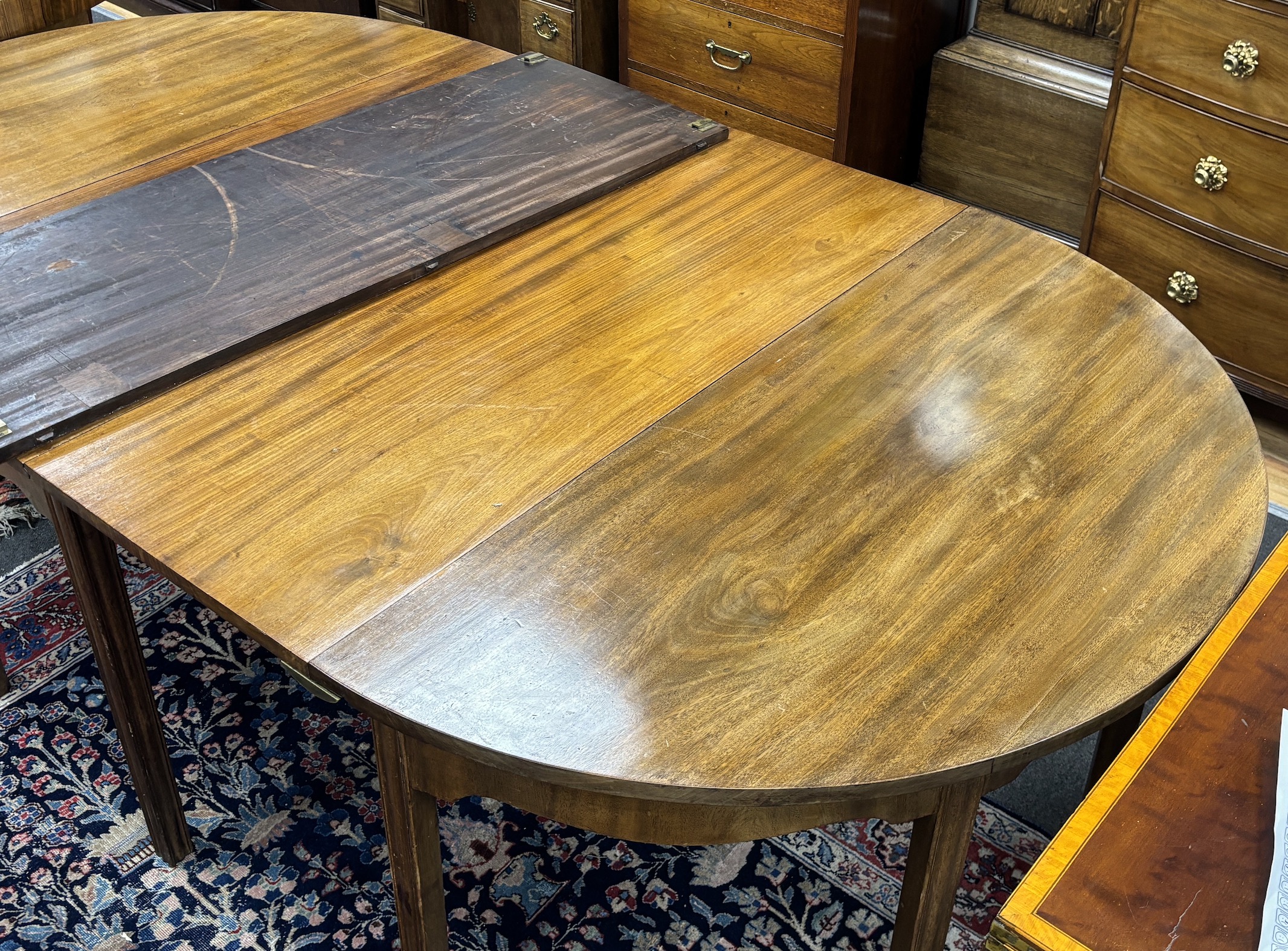 A George III mahogany D end extending dining table, 264cm extended, three spare leaves, width 121cm, height 72cm